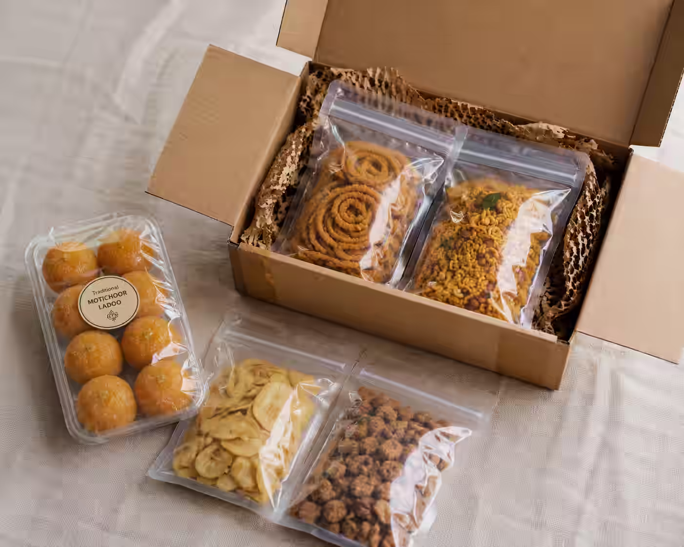Homemade sweets and dry snacks double-sealed and boxed for international courier from India