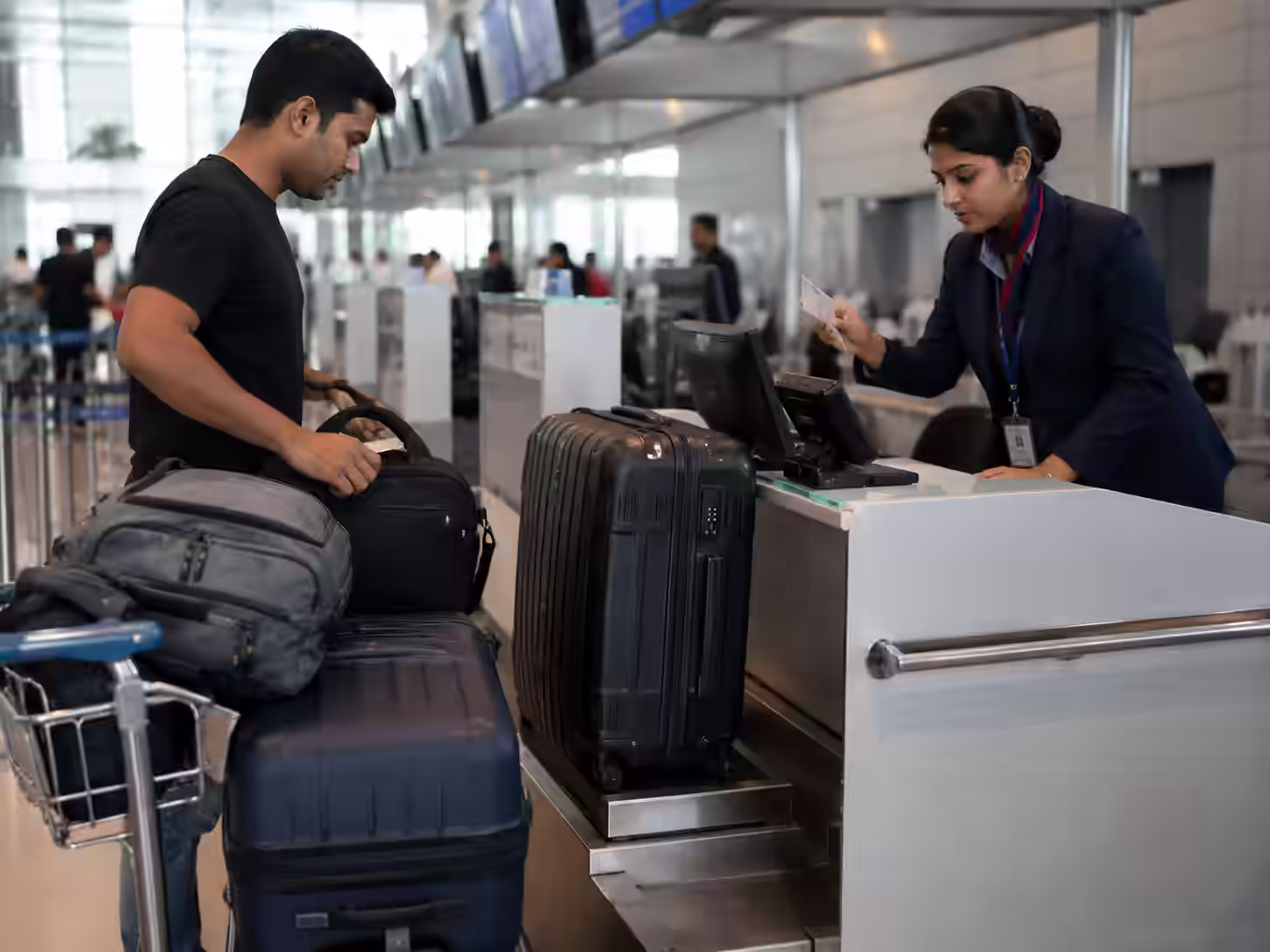 International airport check-in showing excess baggage fee — ShipHit courier alternative from India to USA UK
